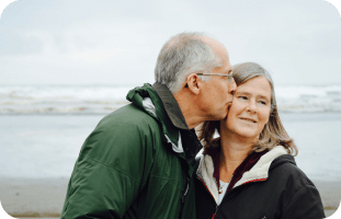 Elderly couple sharing a tender moment, representing real stories of Myasthenia Gravis